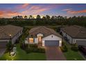 Charming single Gathering home features well-maintained landscaping, a two-car garage, and a lovely tile roof at 20892 Cattail Blvd, Venice, FL 34292