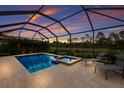 Inviting screened-in pool and spa offer a relaxing outdoor retreat with two lounge chairs at 20892 Cattail Blvd, Venice, FL 34292