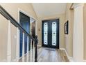 Elegant foyer features a decorative front door and wood-look tile floors at 22235 Panther Loop, Bradenton, FL 34202