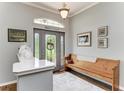 Bright foyer featuring a decorative door, a wooden bench, complementary wall art, and ceramic decorative vases at 22333 Panther Loop, Bradenton, FL 34202