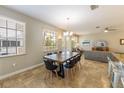 Dining room featuring tile floors, a ceiling fan, and a view to the outdoor landscape at 2309 Avenue C # 200, Bradenton Beach, FL 34217