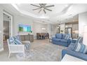 Inviting open-concept living room with modern decor, tile flooring, and plenty of natural light at 2894 Butterfly Jasmine Trl, Sarasota, FL 34240