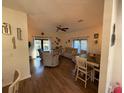 Comfortable living room with ample seating, ceiling fan, and natural light from sliding glass doors at 33 Tee View Pl, Rotonda West, FL 33947
