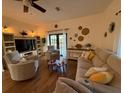 Inviting living room with a plush sofa, armchairs, and a media center for cozy relaxation and entertainment at 33 Tee View Pl, Rotonda West, FL 33947