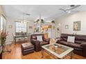 Open-concept living area featuring hardwood floors, vaulted ceilings, and seamless flow to the kitchen at 3883 Tampico Dr, Sarasota, FL 34235