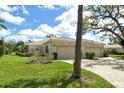 Beautiful single-story home with lush landscaping, a well-maintained lawn, and a two-car garage at 3950 Oakley Greene # 36, Sarasota, FL 34235