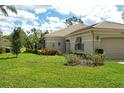 Charming single-story home featuring lush landscaping and elegant exterior details at 3950 Oakley Greene # 36, Sarasota, FL 34235