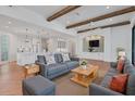 Inviting living room with beamed ceilings, hardwood floors, and an open concept design at 435 La Sila Ct, Punta Gorda, FL 33950