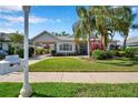 Charming single-story home with lush landscaping, portico, and well-manicured lawn at 4527 Barracuda Dr, Bradenton, FL 34208