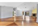 Spacious living room with wood floors, stone fireplace and sliders to the outdoor space at 480 58Th St, Sarasota, FL 34243