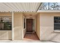 Front entrance with a decorative security door, tile flooring, and natural light from surrounding windows at 4829 Village Gardens Dr # 169, Sarasota, FL 34234