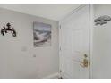 Entryway features a white door, neutral-colored walls adorned with nautical decor and tiled flooring at 501 Lakeside Dr # 501, Bradenton, FL 34210