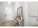 Inviting foyer featuring neutral walls, elegant console table, and decorative mirror, creating a warm welcome at 5235 Coral Reef Way, Bradenton, FL 34211