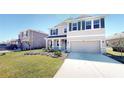 Inviting two-story home with green lawn and stone facade accents at 5269 Grove Mill Loop, Bradenton, FL 34211