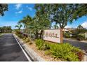 Avista community sign surrounded by vibrant landscaping and palm trees on a bright, sunny day at 5729 Avista Dr, Sarasota, FL 34243