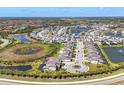 Beautiful aerial view of a luxurious home in a waterfront community with lush landscaping and serene lakes at 5833 Millennium Silver Ct, Sarasota, FL 34238