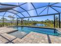 Relaxing screened-in pool with a scenic view of the surrounding nature and pond at 5833 Millennium Silver Ct, Sarasota, FL 34238