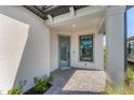 Inviting front porch with a blue glass front door and well-maintained brick-paved walkway at 6260 Fish Eagle Ct, Nokomis, FL 34275