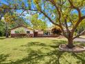Traditional style home features a well manicured lawn, mature landscaping, neutral paint, and brick accents at 6308 Caracara St, Sarasota, FL 34241
