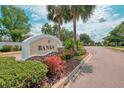 Beautiful neighborhood entrance with palm trees and lush landscaping at The Banks community at 6310 Golden Eye Gln, Lakewood Ranch, FL 34202