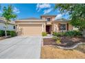 Inviting one-story home with well-kept landscaping, red shutters, and a two-car garage at 6310 Golden Eye Gln, Lakewood Ranch, FL 34202