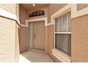 Inviting front entry featuring a stylish door, sidelight window, and neutral color palette at 7309 Regina Royale Blvd # 21, Sarasota, FL 34238