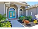 Arched windows and bright blue double doors highlight the entrance of this lovely home at 8615 59Th E St, Parrish, FL 34219