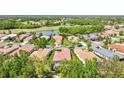 Aerial view of home and surrounding neighborhood with nearby lake and golf course at 9818 Portside Ter, Bradenton, FL 34212