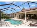 A covered outdoor patio with a pool and a seating area, perfect for outdoor relaxation at 9818 Portside Ter, Bradenton, FL 34212