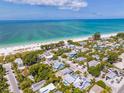 Aerial view of coastal neighborhood with white sandy beaches and turquoise ocean water at 113 Palm Ave, Anna Maria, FL 34216