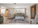 Inviting living room with tile floors, natural light, comfortable seating, and stylish decor at 2620 White Sands Dr, Sarasota, FL 34231