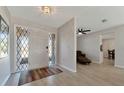Inviting foyer featuring tiled floors, a decorative front door and a glimpse into the living spaces at 2916 Woodcrest Dr, Sarasota, FL 34239