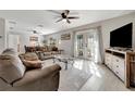 Bright living room featuring a comfortable sofa, modern furnishings and French doors to the exterior at 2916 Woodcrest Dr, Sarasota, FL 34239