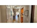 Inviting hallway leading to a bright living space, featuring tiled floors and beach themed decor at 3390 Ramblewood Ct, Sarasota, FL 34237