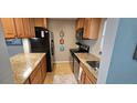 Compact kitchen with granite countertops, stainless steel appliances, and stylish decor at 3390 Ramblewood Ct, Sarasota, FL 34237