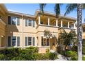 Inviting two-story home with lush landscaping, a covered entry, and charming architectural details at 3736 82Nd Avenue E Cir # 104, Sarasota, FL 34243