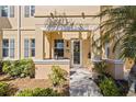 Charming front porch with seating, a decorative wreath, and a well-maintained garden at 3736 82Nd Avenue E Cir # 104, Sarasota, FL 34243