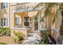 Charming front porch with seating, a decorative wreath, and a well-maintained garden at 3736 82Nd Avenue E Cir # 104, Sarasota, FL 34243