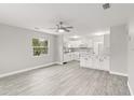 Open-concept living room and kitchen area with neutral walls and updated flooring at 4111 Rockefeller Ave, Sarasota, FL 34231