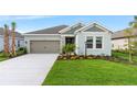 Beautiful single-story home with a well-kept lawn, palm trees, and a two-car garage offering great curb appeal at 4240 Pond Brook Ct, Bradenton, FL 34211