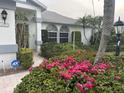 Charming home with lush landscaping and a brick walkway leading to the front door at 4538 Hamlets Grove Dr, Sarasota, FL 34235