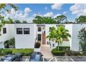 A well-maintained building with a brick-paved entryway and neatly landscaped surroundings, inviting guests and residents alike at 5042 Marsh Field Rd # 16, Sarasota, FL 34235