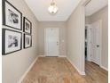 Inviting entryway with hardwood floors, neutral walls adorned with artwork, and a view into other rooms at 5307 Senza Trl, Palmetto, FL 34221