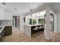 Contemporary kitchen with stainless appliances, island with seating and tile floors at 577 Corwood Dr, Sarasota, FL 34234