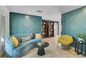 Interior living room with hardwood floors, colorful sofa and custom built-in bookshelves at 577 Corwood Dr, Sarasota, FL 34234
