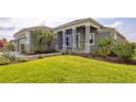 Attractive single-story home with a manicured lawn and stylish stone-accented entryway columns at 659 Rosemary Cir, Bradenton, FL 34212