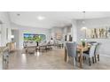 Open-concept living room with tile floors, contemporary furnishings, and plenty of natural light at 7130 Plantation St, Englewood, FL 34224