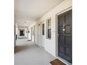 Exterior hallway featuring unit entrances and consistent lighting at 7461 W Country Club N Dr # 207, Sarasota, FL 34243