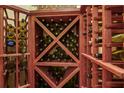 Wine cellar with wooden shelves and bottles of wine at 7580 Preservation Dr, Sarasota, FL 34241