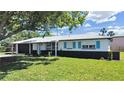 Charming single-story home with a well-manicured lawn and cute blue shutters at 7797 Barry Ct, Seminole, FL 33772